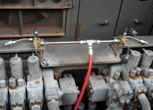 A fire suppression system with multiple heads for distribution of an agent throughout various areas of the machinery.