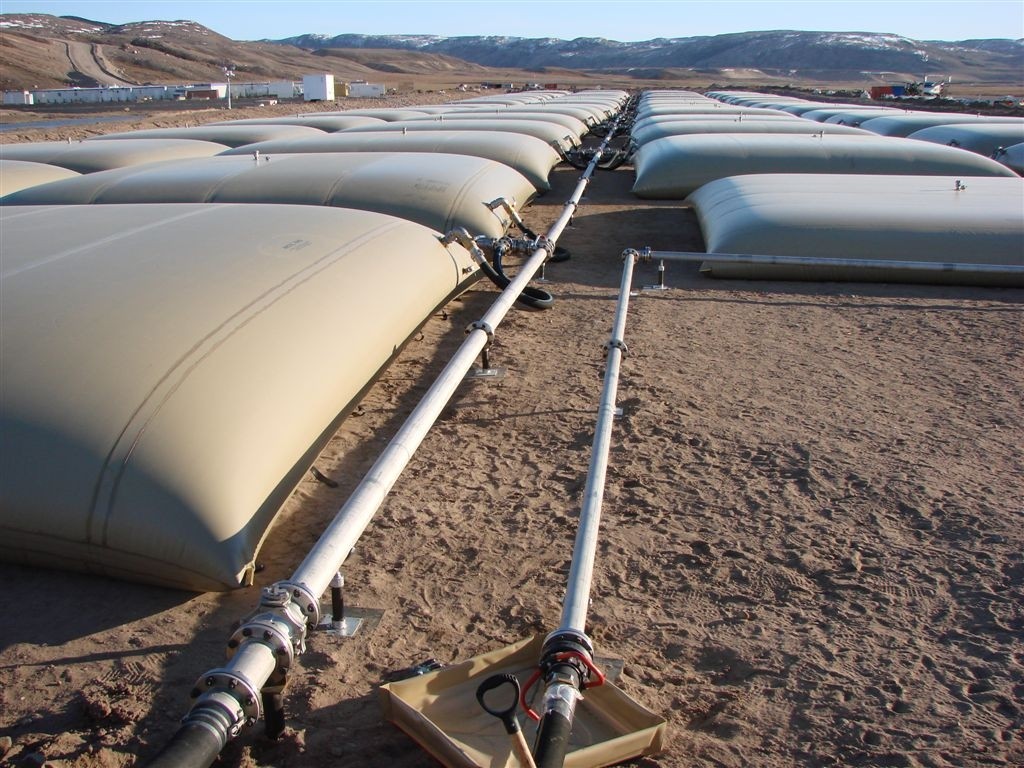 A field of Arctic King collapsible tanks on Baffin Island. Note the isolation of the pipe joint to contain a potential leak.