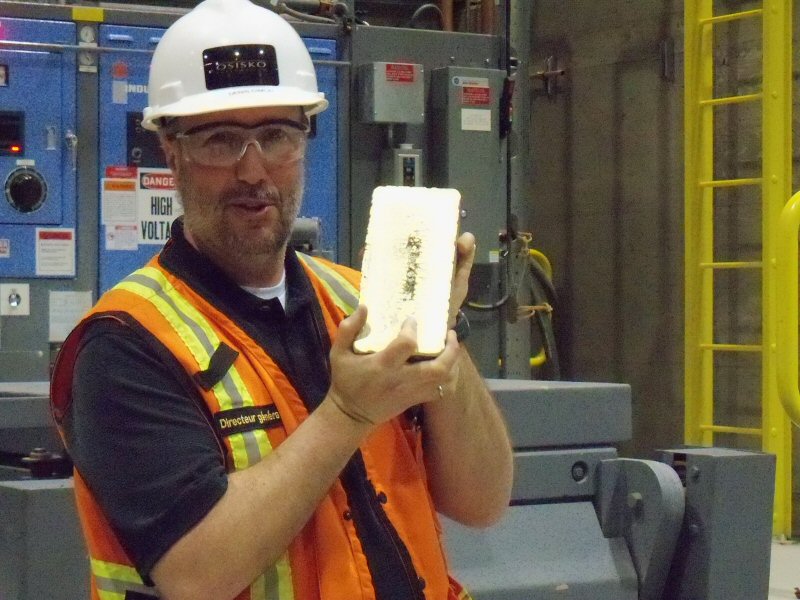Denis Cimon, general manager of the Canadian Malartic mine, holds the first dor bar poured in April 2011. (Photo: Osisko Mining)